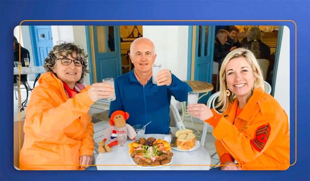 Droomhuis Gezocht deelnemers Judith en Jan Willem zitten met Carrie ten Napels aan een tafel met eten en proosten.